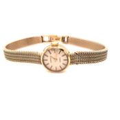 A 9ct GOLD LADIES GARRARD PRESENTATION QUARTZ WATCH ON A MILANESE 9ct GOLD BRACELET STRAP,