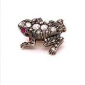 A DIAMOND AND RUBY FROG BROOCH, OLD CUT DIAMONDS ADORN THE BODY COMPLETED WITH RUBY SET EYES. LENGTH