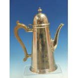 A HALLMARKED SILVER COFFEE POT WITH WOODEN HANDLE DATED 1959 LONDON, FOR GOWLAND BROTHERS. HEIGHT