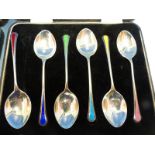 A SET OF SIX HALLMARKED SIVER AND ENAMEL CASED COFFEE SPOONS, A FURTHER SET OF SIX, PART SET OF FIVE