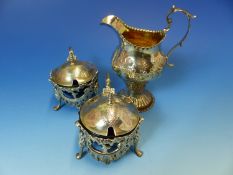 A SILVER HALLMARKED CREAM JUG WITH REPOUSSE DECORATION AND A GILDED INNER DATED 1780 LONDON,FOR