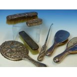 A HALLMARKED SILVER THREE PIECE DRESSING TABLE SET, A FURTHER REPOUSSE DECORATED MIRROR AND BRUSH, A