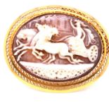 AN OVAL CAMEO BROOCH OF CHARIOT AND DRIVER PULLED BY THREE HORSES IN FULL GALLOP, SET IN A PIERCED