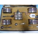 A CASED HALLMARKED SILVER FIVE PIECE CRUET SET WITH ASSOCIATED SPOONS.