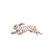 A VICTORIAN RUNNING HARE OLD CUT DIAMOND SET BROOCH. THE PAVE SET BODY COMPLETED WITH A RUBY SET
