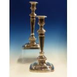 A PAIR OF TALL PLAIN RECTANGULAR WEIGHTED CANDLESTICKS WITH GADROON BORDERS, DATED SHEFFIELD 1929,