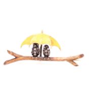 OLD CUT DIAMOND SET BIRDS NESTLED ON A BRANCH UNDER A GOLDEN UMBRELLA IN THE FORM OF A BROOCH.