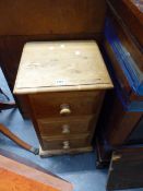 A PINE BEDSIDE CABINET AND A MODERN DINING TABLE.