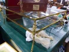A GILT BRASS FRAMED TWO TIER COFFEE TABLE.