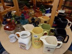 A COLLECTION OF VARIOUS PUB JUGS AND VARIOUS FLAGONS.