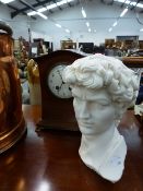 AN EDWARDIAN MANTLE CLOCK AND A SMALL BUST.