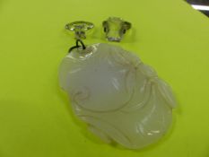 A WHITE JADE ORIENTAL CARVED PENDANT AND TWO SOLITAIRE RINGS.