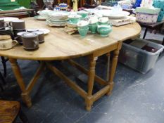 A PINE DROP LEAF KITCHEN TABLE TOGETHER WITH A 19th.C.OAK DROP LEAF TABLE.