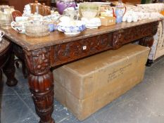 A GOOD 19th.C. CARVED OAK TWO DRAWER WRITING TABLE.