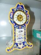 A FRENCH POTTERY CASED MANTLE CLOCK.