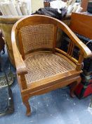 A CANE SEATED ARMCHAIR.