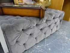 A BUTTON UPHOLSTERED STOOL.