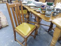AN OAK DRAW LEAF TABLE AND FOUR CHAIRS.