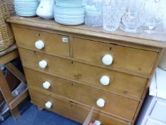 A VICTORIAN STRIPPED PINE CHEST OF DRAWERS.