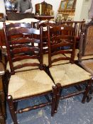 A SET OF FOUR LADDER BACK CHAIRS AND AN ARTS AND CRAFTS ARMCHAIR.