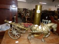 A TRENCH ART JUG AND A BRASS HORSE DRAWN CANNON.