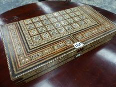 A FOLDING CHESS AND BACKGAMMON BOARD INLAID IN THE MOORISH TASTE. W 50cms