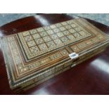 A FOLDING CHESS AND BACKGAMMON BOARD INLAID IN THE MOORISH TASTE. W 50cms