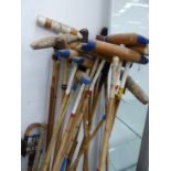 A LARGE COLLECTION OF POLO MALLETS AND HELMETS, TOGETHER WITH TWO SHOOTING STICKS, ETC (QTY).