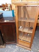 AN EARLY 20th.C. "DISQUE" RECORD CABINET AND AN OAK TAMBOUR FRONT CABINET.