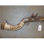 AN ARABIAN FLINTLOCK MUSKET WITH RAMROD, INSCRIBED ON THE LOCK PLATE THE WOOD WORK INLAID IN