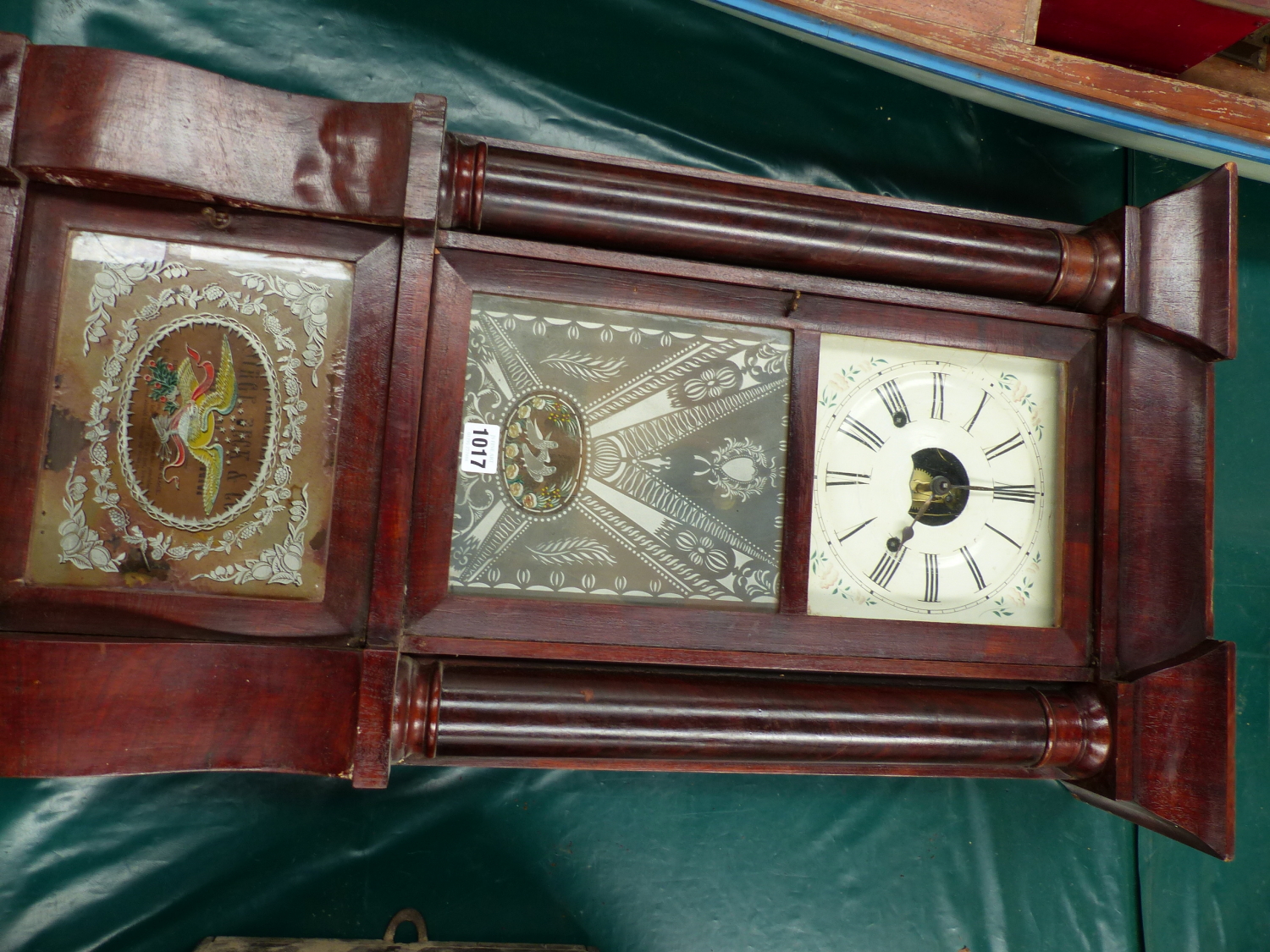 A GLAZED MAHOGANY WALL CLOCK BY BIRGE, BECK & Co. BRISTOL, CONN. THE PENDULUM MOVEMENT STRIKING ON A