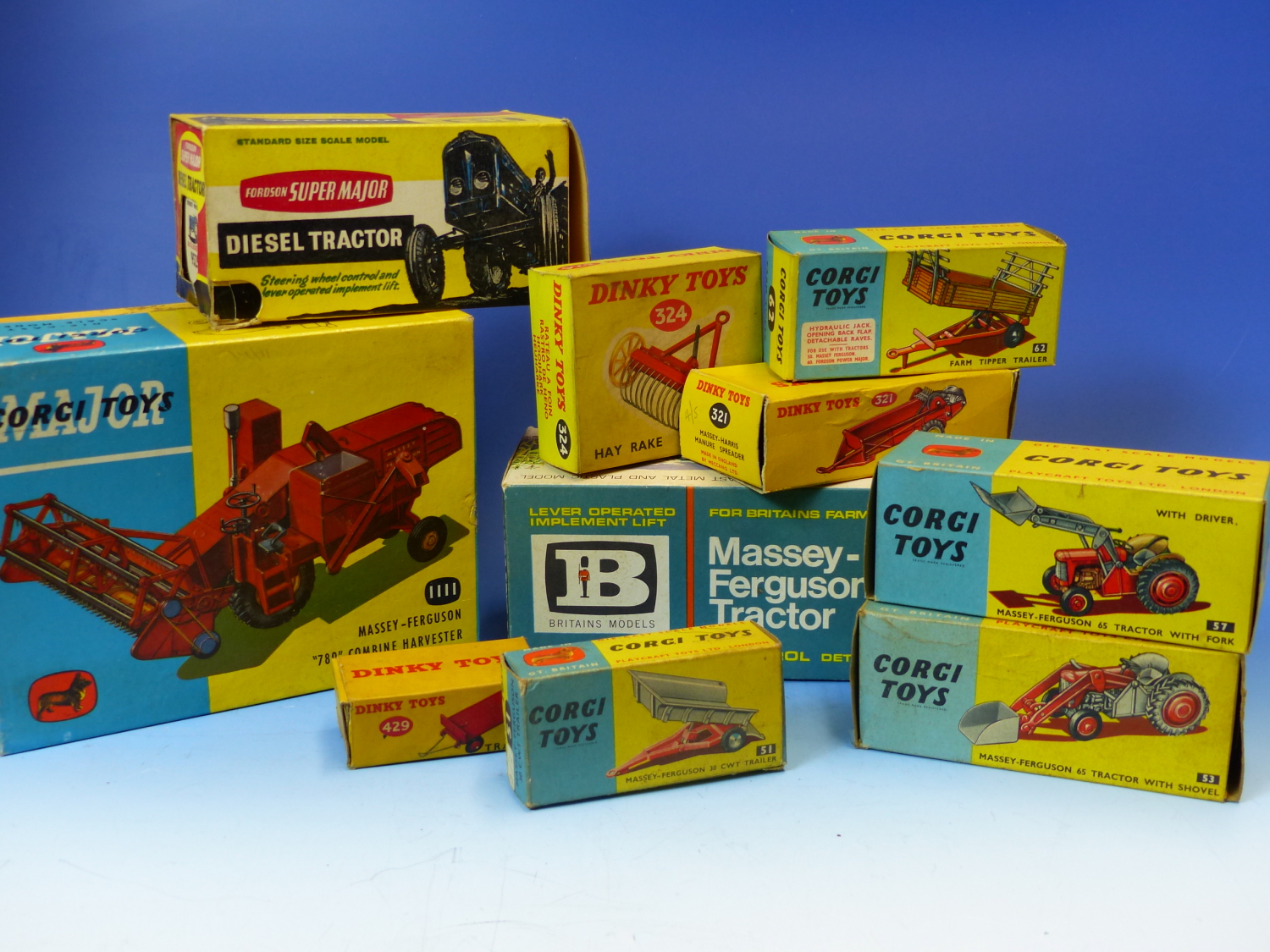 A COLLECTION OF BRITAINS, DINKY AND CORGI TOY FARM VEHICLES, TREES AND ANIMALS.