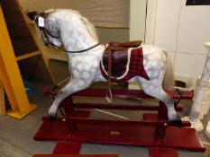 AN EARLY 20th.C.ROCKING HORSE ON TRESTLE BASE, RESTORED 2001 BY H&D CRAMMOND. HOOF TO EAR 97cms.