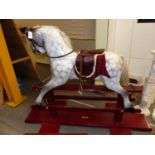 AN EARLY 20th.C.ROCKING HORSE ON TRESTLE BASE, RESTORED 2001 BY H&D CRAMMOND. HOOF TO EAR 97cms.