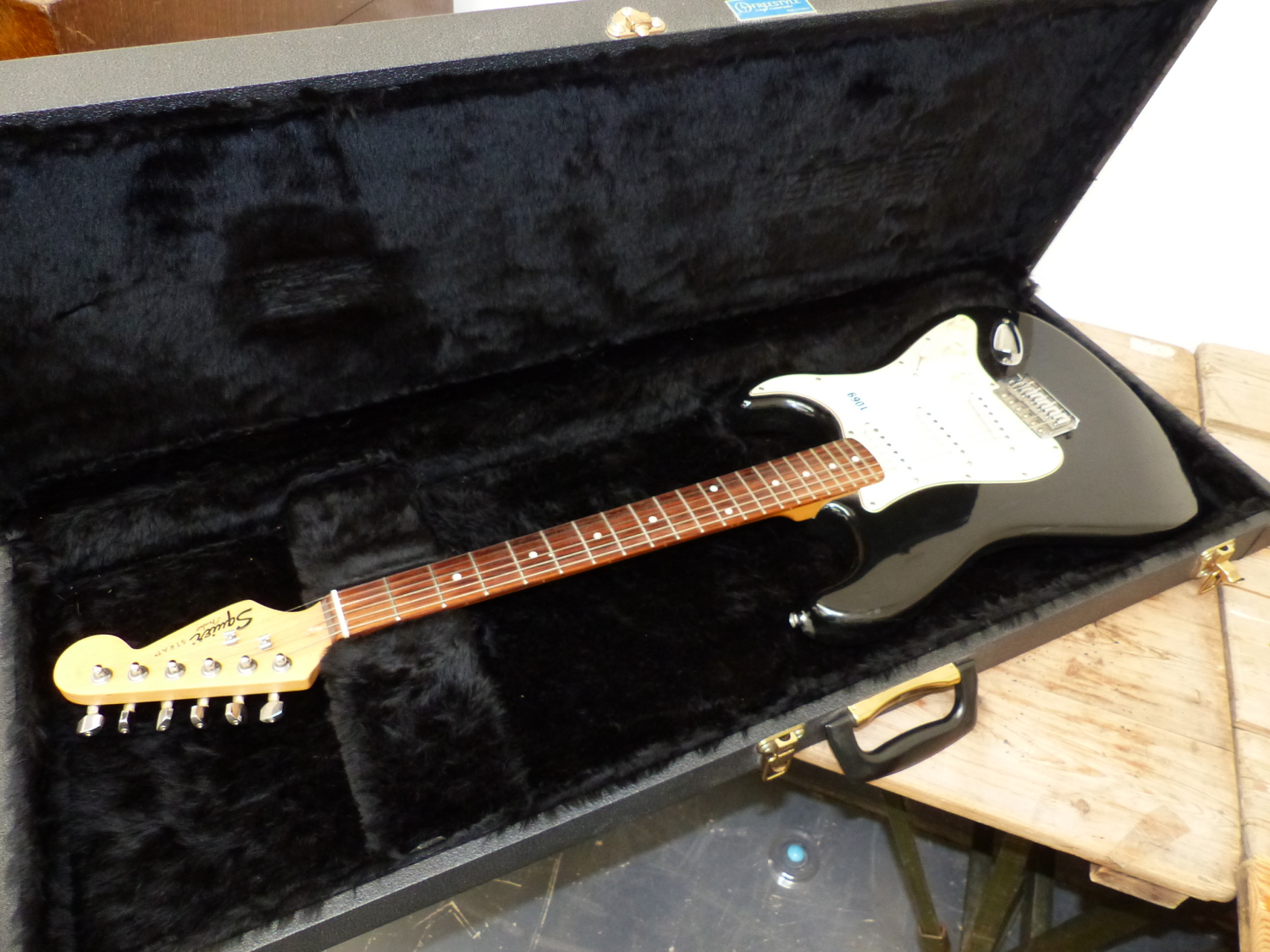 A SQUIRE STRAT BLACK BODY ELECTRIC GUITAR IN CARRYING CASE.