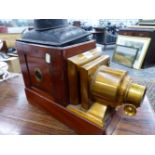 A MAHOGANY MAGIC LANTERN WITH LACQUERED BRASS LENS MOUNTS. W 41cms.