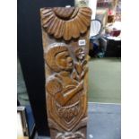 AN ANTIQUE CARVED HARDWOOD SHIPS TIMBER ELEMENT DEPICTING SPOUTING FISH AND NATIVE AFRICAN HOLDING A