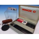 A BOXED MINOX C CAMERA WITH FLASH ATTACHMENT AND INSTRUCTION BOOKLETS TOGETHER WITH ANOTHER