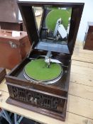 A JAPANESE SANKUDO DISC GRAMOPHONE, THE MAHOGANY LID MIRRORED INSIDE OVER A TURNTABLE WITH A DUST