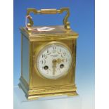 A FRENCH GLAZED BRASS MANTEL CLOCK RETAILED BY JAMES WALKER, THE FLORAL SWAGGED DIAL WITH ARABIC