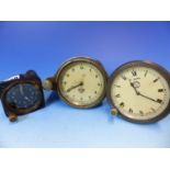 THREE CAR CLOCKS, ONE BY JAEGER. Dia. 9.5cms. ANOTHER BY SMITHS, Dia. 9cms. THE LAST IN BLACKENED