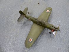 AN AMERICAN WORLD WAR II MODEL WAR PLANE, THE THREE BLADED PROP POWERED BY A LIVE FUEL ENGINE, THE