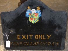 A BLACK GROUND RACE TRACK EXIT SIGN WITH A VARIATION OF THE ARMORIAL OF THE LOWNDES-GORST FAMILY