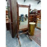 A CARVED MAHOGANY REGENCY CHEVAL MIRROR, HIPPED SABRE LEGS ENDING IN BRASS CAP CASTERS. H. 183 x