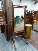 A CARVED MAHOGANY REGENCY CHEVAL MIRROR, HIPPED SABRE LEGS ENDING IN BRASS CAP CASTERS. H. 183 x