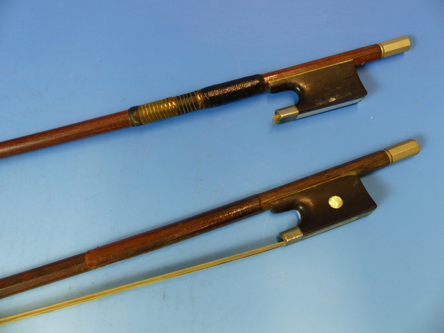 TWO VIOLIN BOWS, ONE STAMPED DODD TO ONE SIDE OF THE FROG AND GERMANY ON THE OTHER.