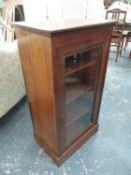 A 19th.C.MUSIC CABINET, THE GLAZED DOOR ENCLOSING TWO SHELVES ABOVE THE PLINTH FOOT. W 51 x D 35.5 x