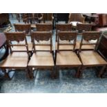AN INTERESTING SET OF EIGHT VICTORIAN GOTHIC REVIVAL OAK HALL CHAIRS WITH CARVED BACKS, TURNED