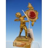 AN ORMOLU WATCH STAND IN THE FORM OF A ROCOCO FRAME HELD UP BY A CUPID ONYX PLINTH. H 19cms.