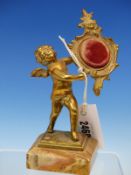 AN ORMOLU WATCH STAND IN THE FORM OF A ROCOCO FRAME HELD UP BY A CUPID ONYX PLINTH. H 19cms.